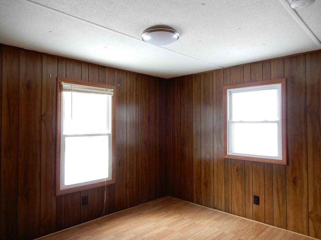1 Heritage Drive Warren, MA 01585 - Photo 11 of 20 a view of an empty room with wooden floor and a window