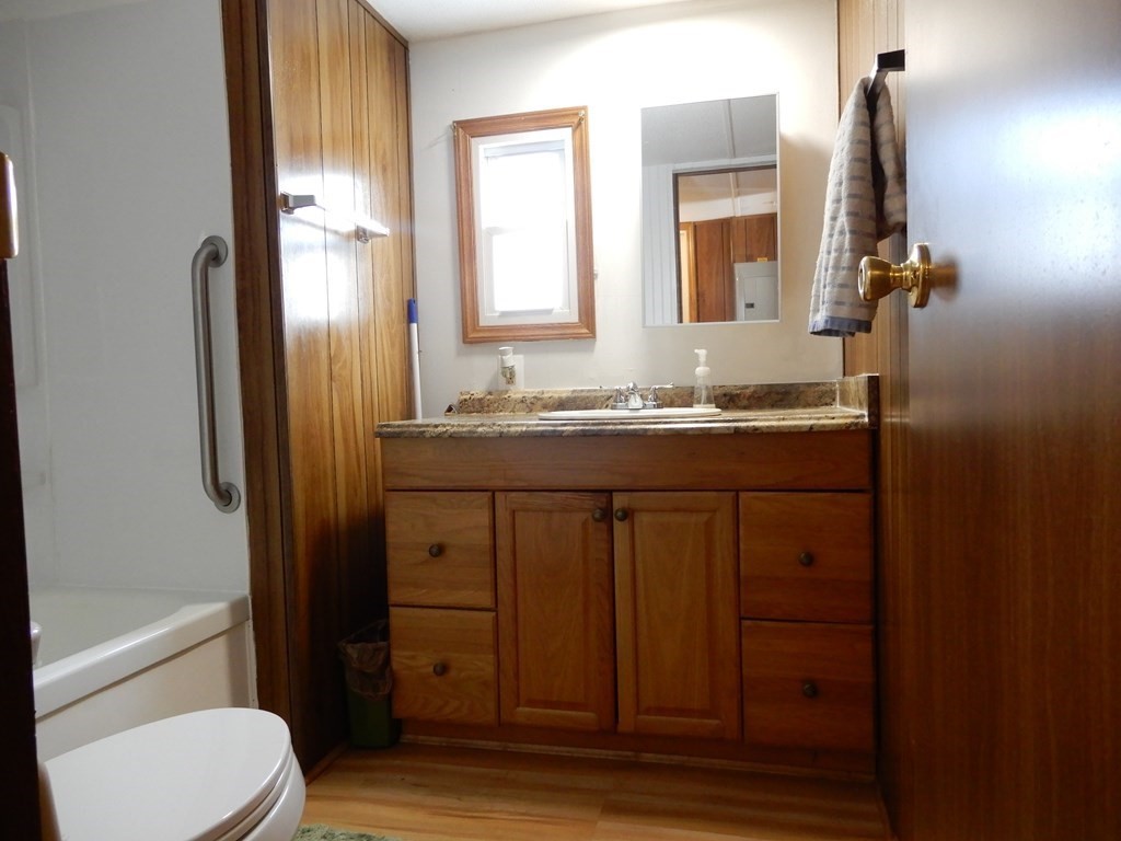 1 Heritage Drive Warren, MA 01585 - Photo 15 of 20 a bathroom with a granite countertop sink toilet and mirror
