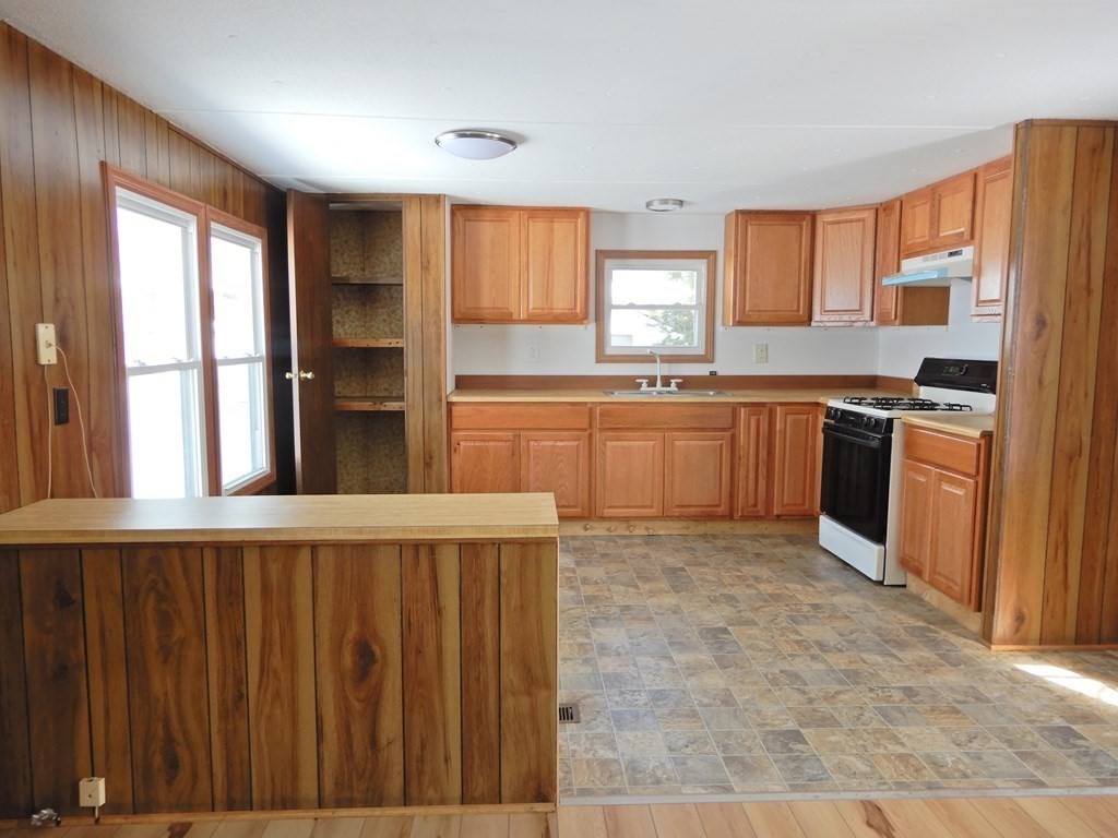 1 Heritage Drive Warren, MA 01585 - Photo 4 of 20 a kitchen with stainless steel appliances granite countertop a refrigerator a sink dishwasher and wooden cabinets