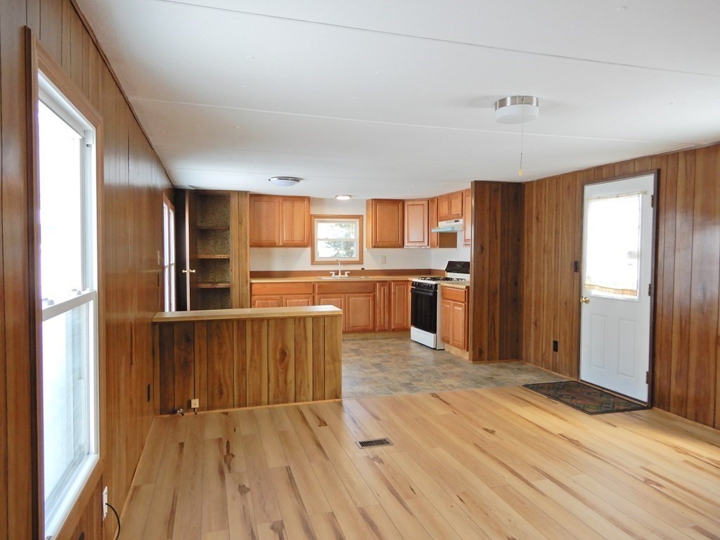 1 Heritage Drive Warren, MA 01585 - Photo 5 of 20 a kitchen with stainless steel appliances granite countertop a refrigerator a stove top oven a sink and dishwasher with wooden floor