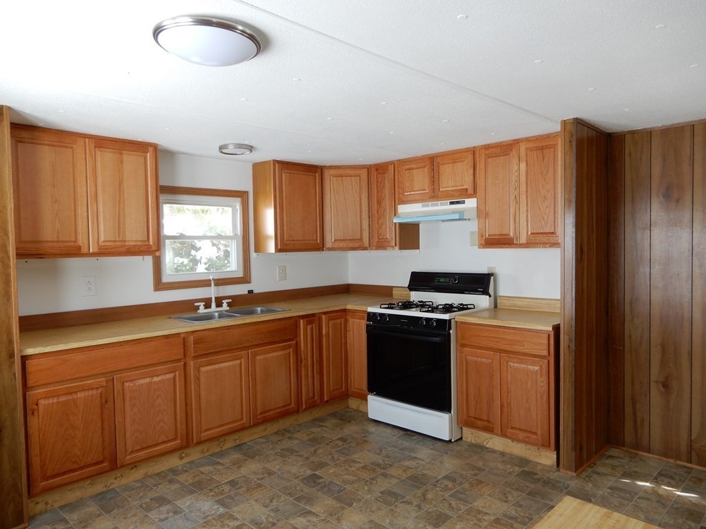 1 Heritage Drive Warren, MA 01585 - Photo 6 of 20 a kitchen with stainless steel appliances granite countertop a stove a sink dishwasher and a refrigerator