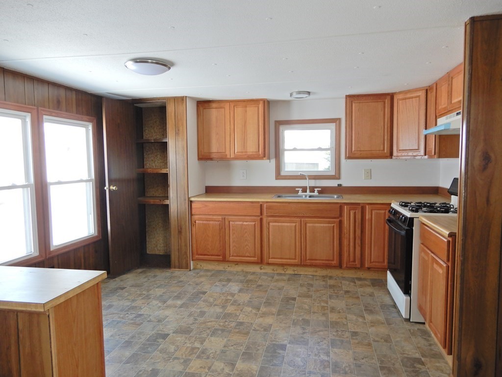 1 Heritage Drive Warren, MA 01585 - Photo 7 of 20 a kitchen with a stove a sink and a refrigerator