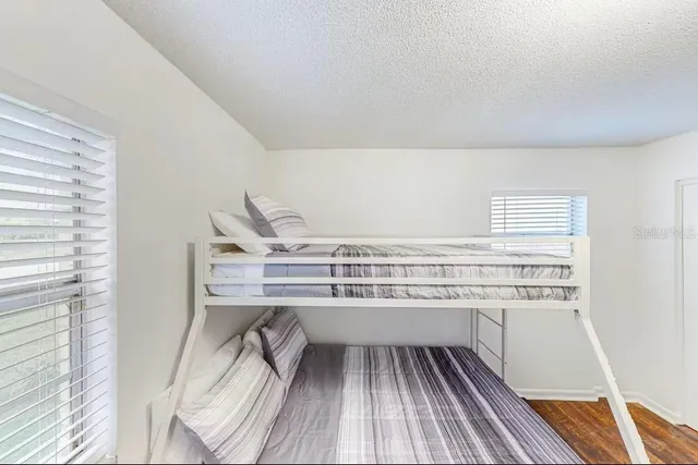 a kitchen with a sink and wooden floor