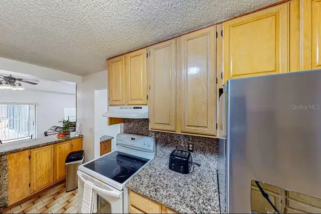 a kitchen with a sink and a refrigerator