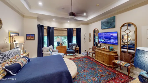 a living room with furniture a rug and a flat screen tv