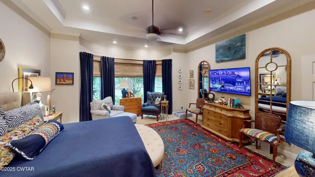 a living room with furniture a rug and a flat screen tv