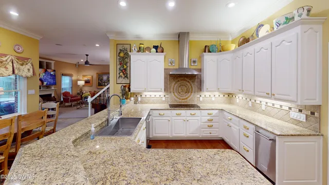 a view of kitchen with stainless steel appliances granite countertop a refrigerator and a sink