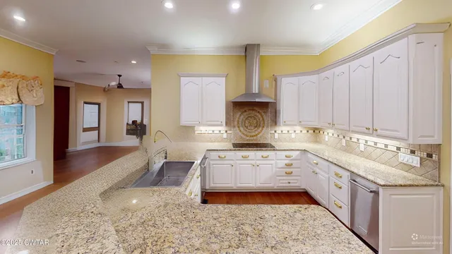 a view of a kitchen with stainless steel appliances granite countertop a refrigerator and a sink