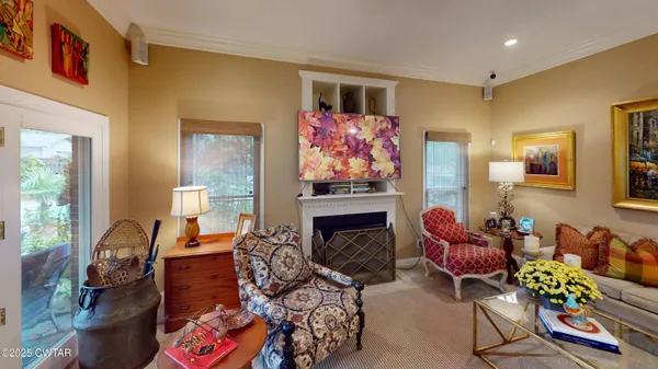 a living room with furniture and painting on the wall