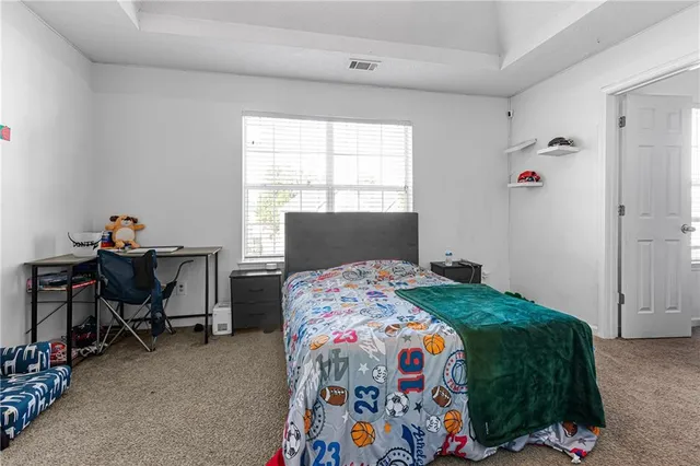 a bedroom with a bed and a window