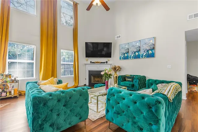 a living room with fireplace furniture and a flat screen tv