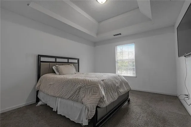 a bedroom with a bed and window