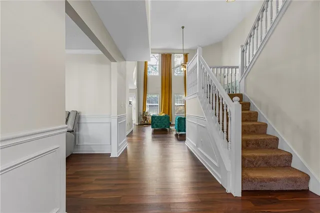 a view of entryway and hall with wooden floor