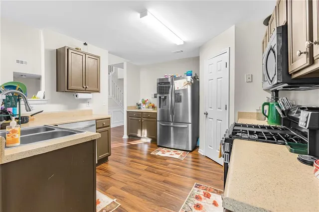 a kitchen with stainless steel appliances granite countertop a refrigerator stove and oven