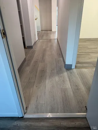 a view of a hallway with wooden floor