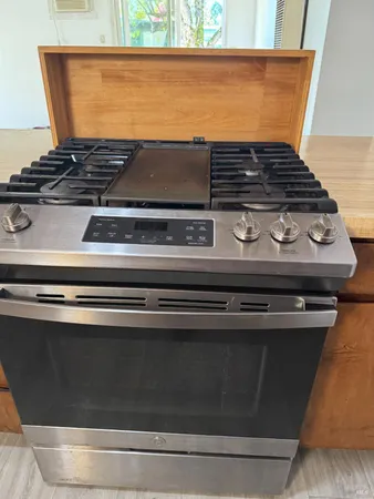 a stove sitting inside of a kitchen