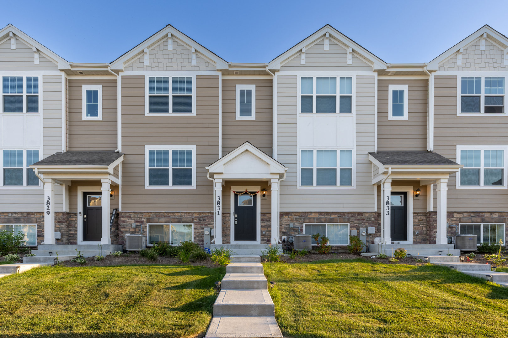 a front view of a house with swimming pool and chairs