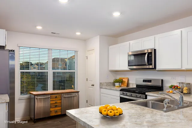 a kitchen with stainless steel appliances granite countertop a stove and a sink