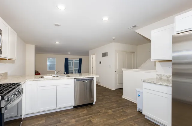 a kitchen with a stove a sink and a refrigerator