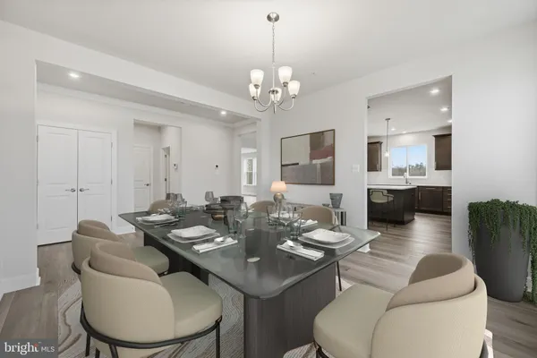 a living room with furniture a chandelier and a dining room