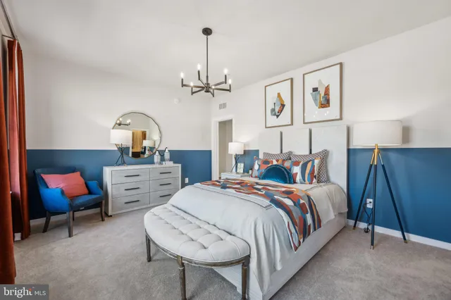 a bedroom with bed and a chandelier