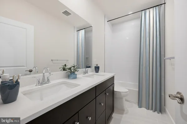a bathroom with a sink double vanity and a mirror