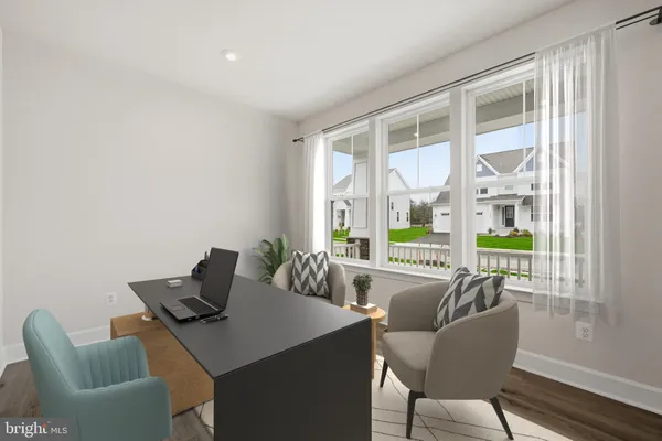 a view of a dining room with furniture large windows and wooden floor