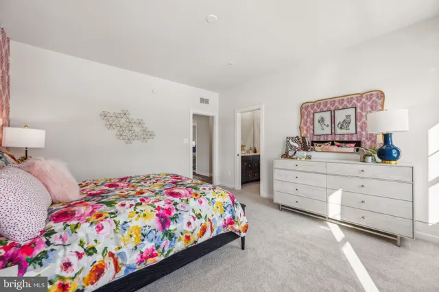 a bedroom with a bed and dresser