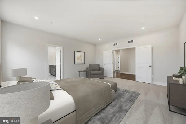 a spacious bedroom with a large bed and a couch