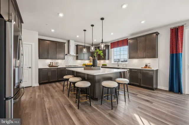 a large kitchen with a table and chairs