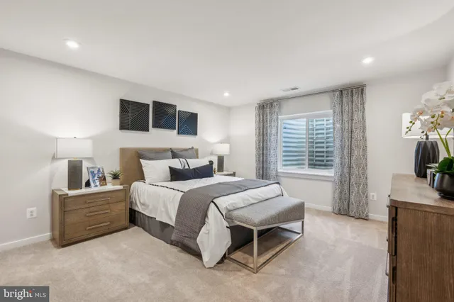 a spacious bedroom with a bed and a flat screen tv