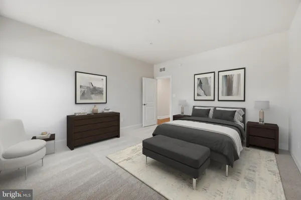a bedroom with a bed and a couch