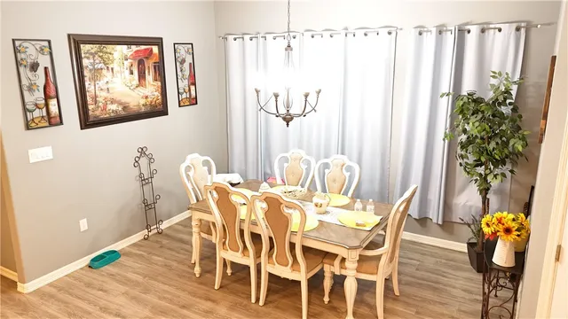 a view of a dining room with furniture and chandelier