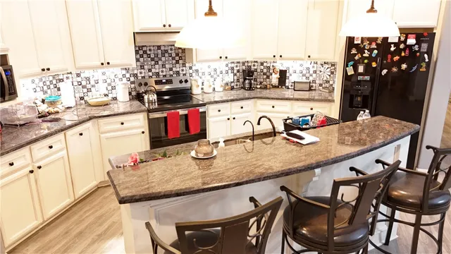 a kitchen with a table chairs and cabinets