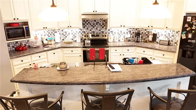 a dining table with chairs and flat screen tv