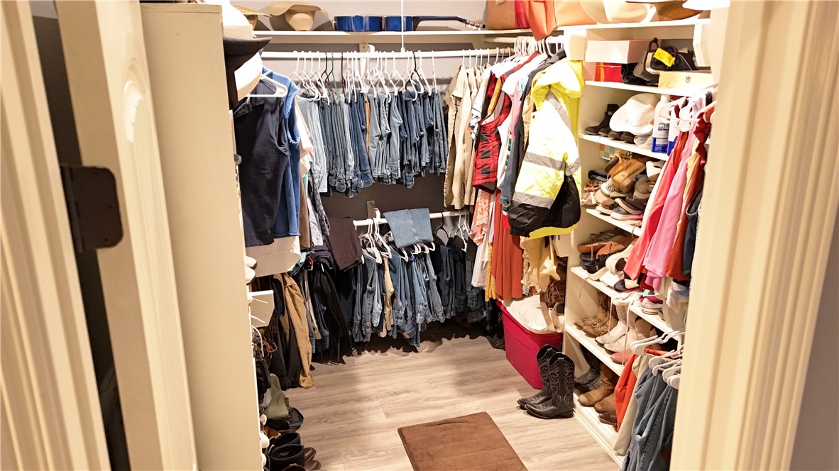 570 County Road 137 Alice, TX 78332 - Photo 18 of 30 a view of walk in closet with clothes