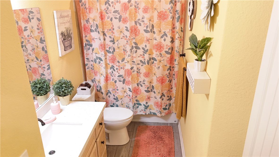 570 County Road 137 Alice, TX 78332 - Photo 27 of 30 a white toilet sitting next to a shower curtain