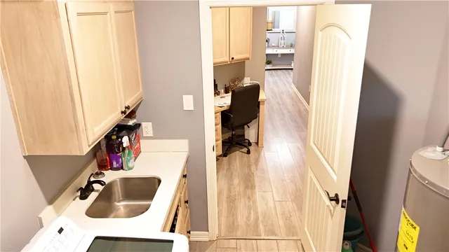a room with a chair and washer dryer