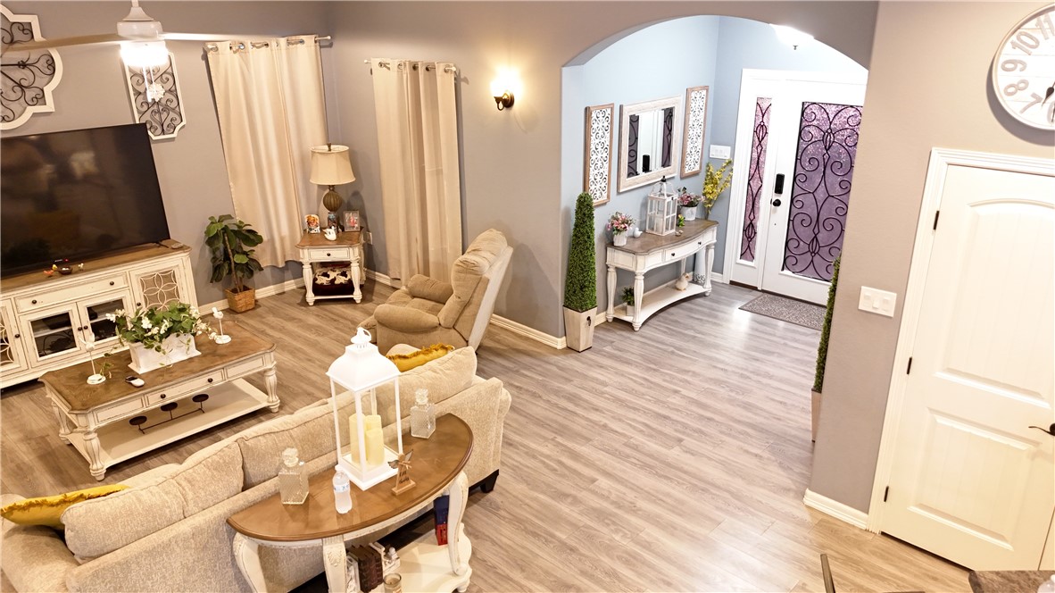 570 County Road 137 Alice, TX 78332 - Photo 10 of 30 a view of a livingroom with furniture hardwood floor and a flat screen tv
