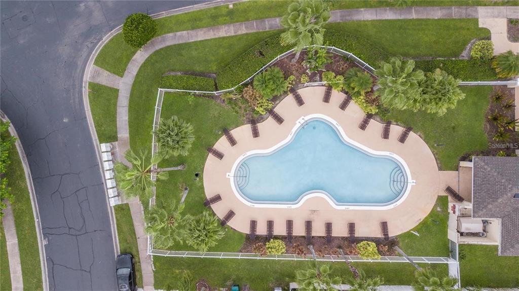 1112 Timberbend Circle Orlando, FL 32824 - Photo 18 of 32 a view of a swimming pool with a garden