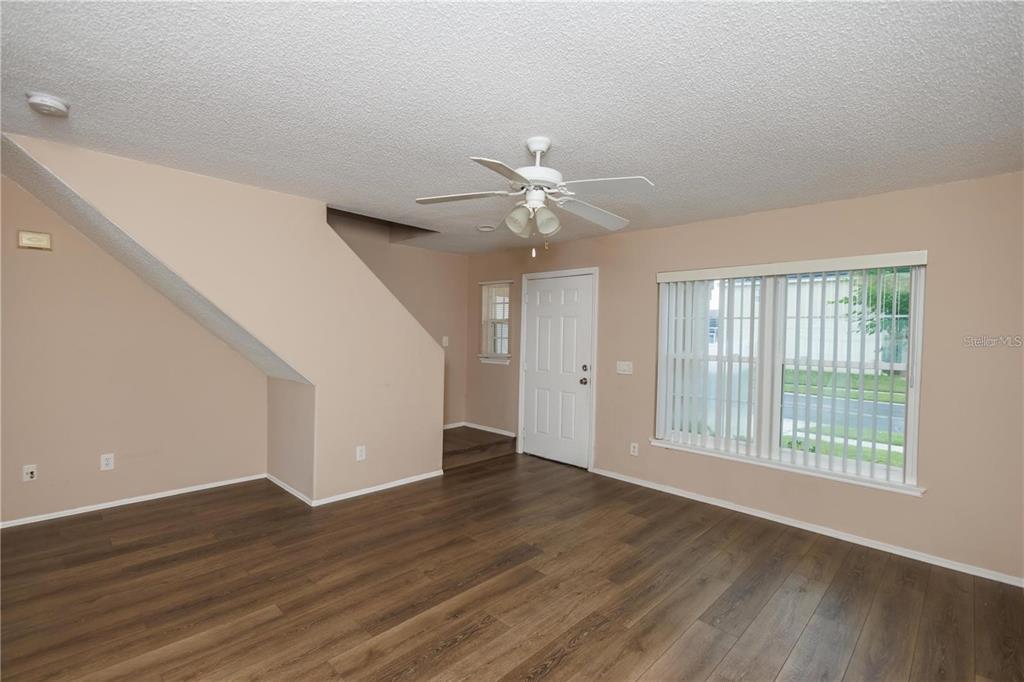 1112 Timberbend Circle Orlando, FL 32824 - Photo 20 of 32 a view of an empty room with wooden floor and a window