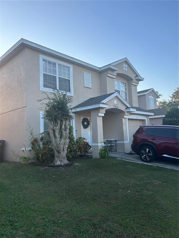 1112 Timberbend Circle Orlando, FL 32824 - Photo 2 of 32 a front view of a house with a garden and plants