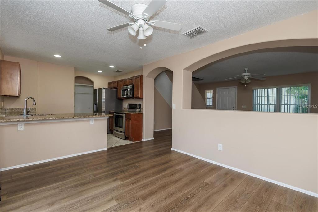 1112 Timberbend Circle Orlando, FL 32824 - Photo 21 of 32 an open kitchen with wooden floor and a kitchen island