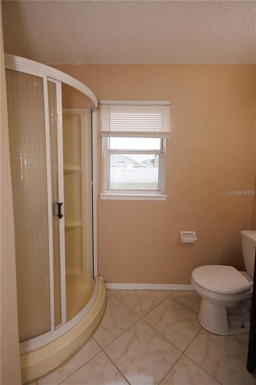 1112 Timberbend Circle Orlando, FL 32824 - Photo 25 of 32 a bathroom with a toilet and a shower