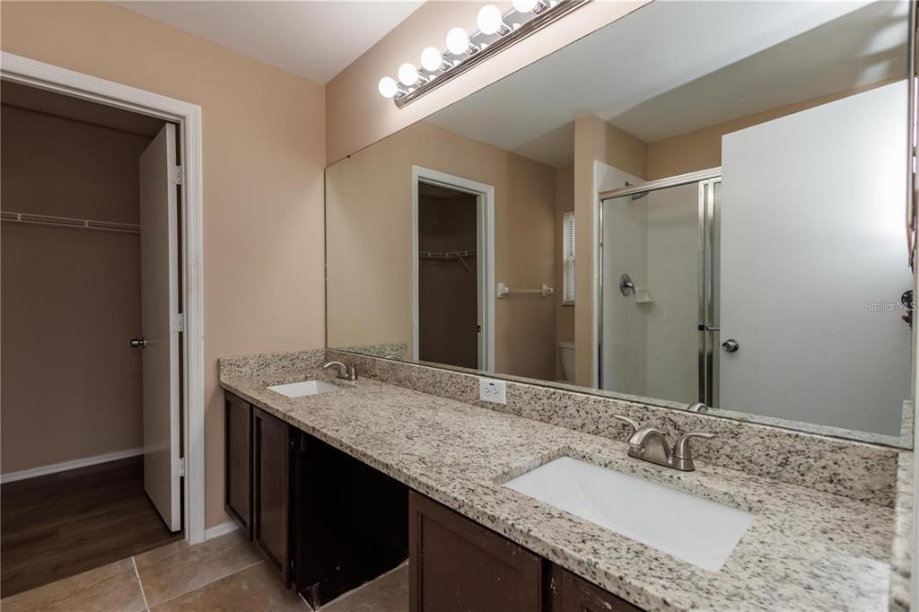 1112 Timberbend Circle Orlando, FL 32824 - Photo 30 of 32 a bathroom with a granite countertop double vanity sink and a mirror