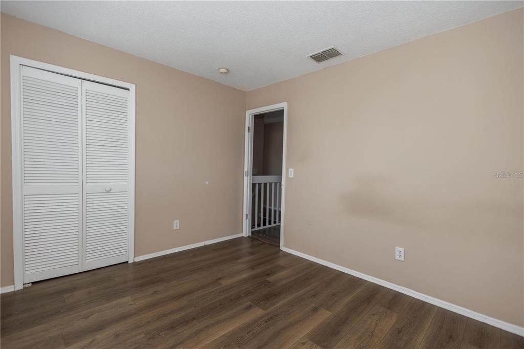1112 Timberbend Circle Orlando, FL 32824 - Photo 32 of 32 a view of an empty room with wooden floor and closet
