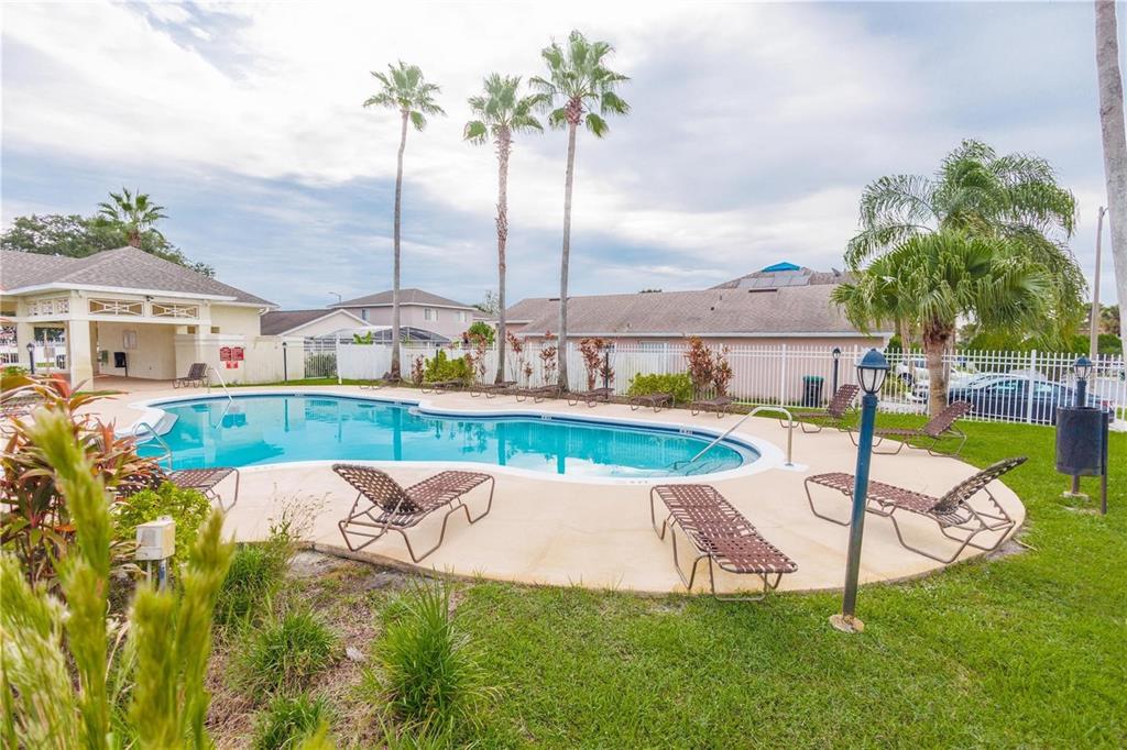 1112 Timberbend Circle Orlando, FL 32824 - Photo 4 of 32 a view of a swimming pool with a garden