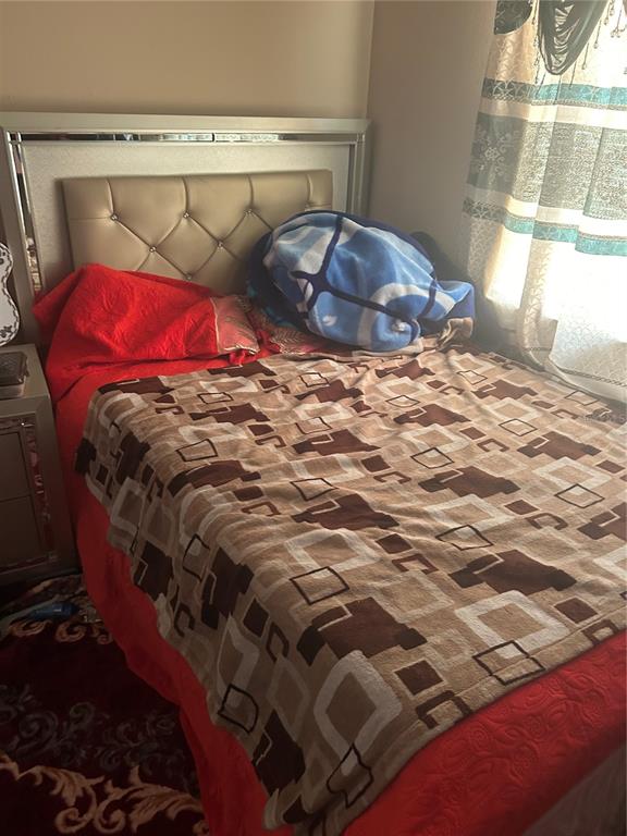 1112 Timberbend Circle Orlando, FL 32824 - Photo 8 of 32 a bed sitting in a bedroom next to a window