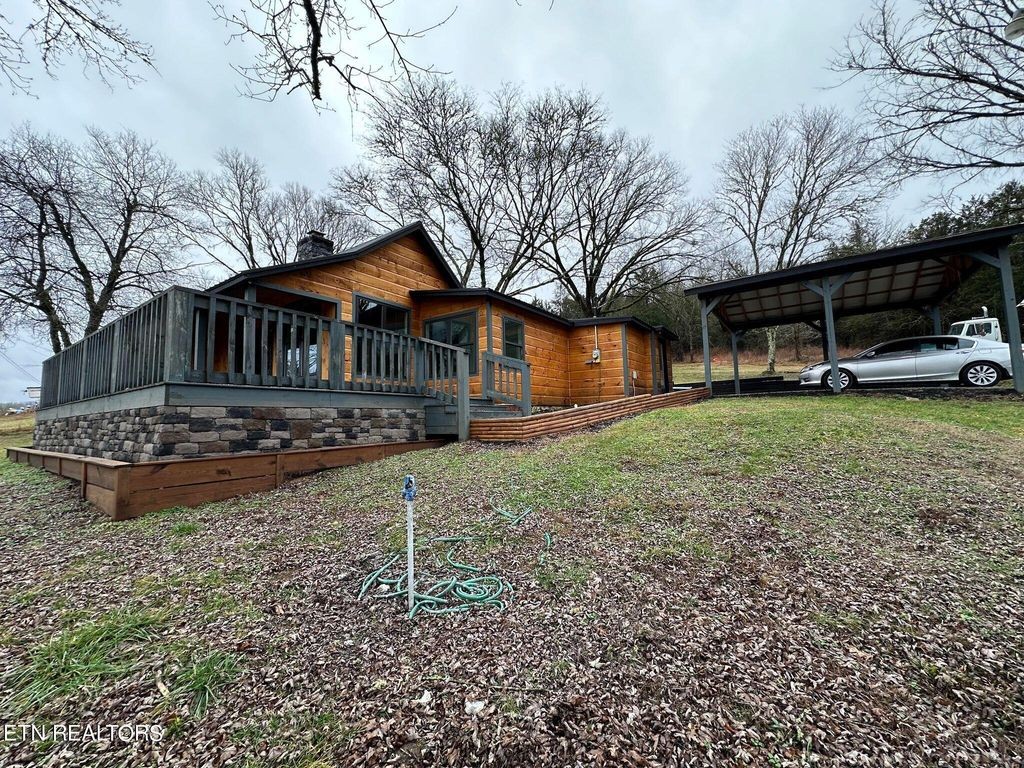 363 Enigma Road Chestnut Mound, TN 38552 - Photo 1 of 60 a front view of a house with garden