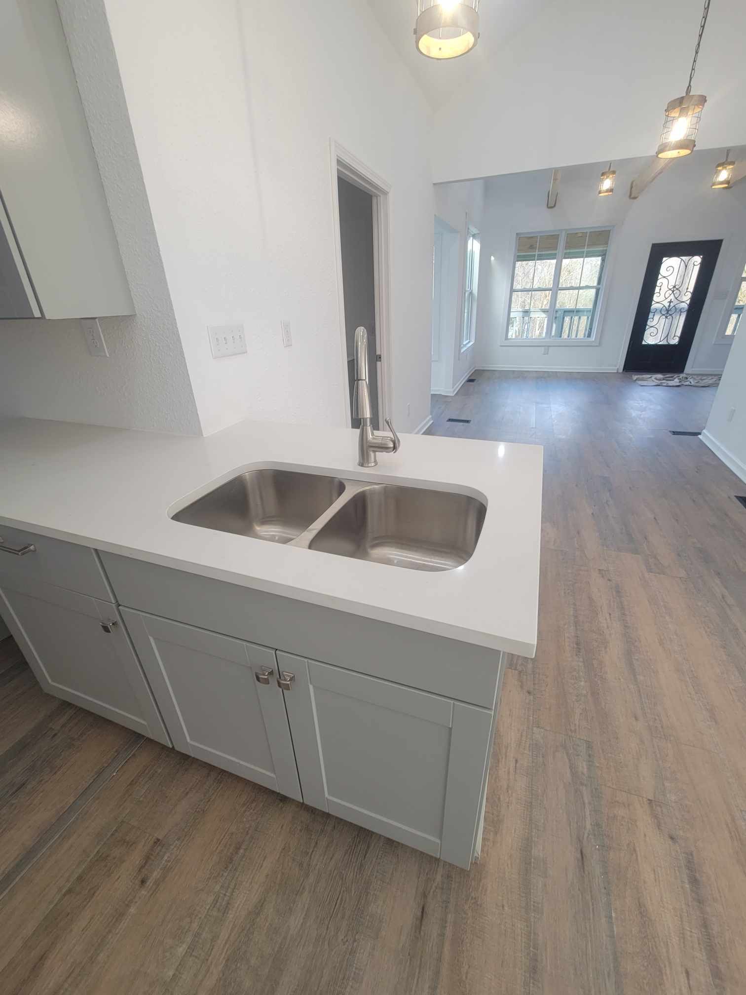 363 Enigma Road Chestnut Mound, TN 38552 - Photo 16 of 60 a kitchen with a sink and dishwasher with wooden floor